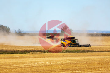 Combine in barley field