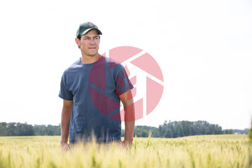 Farmer standing in a wheat field