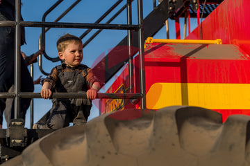 Young boy on an air seeder